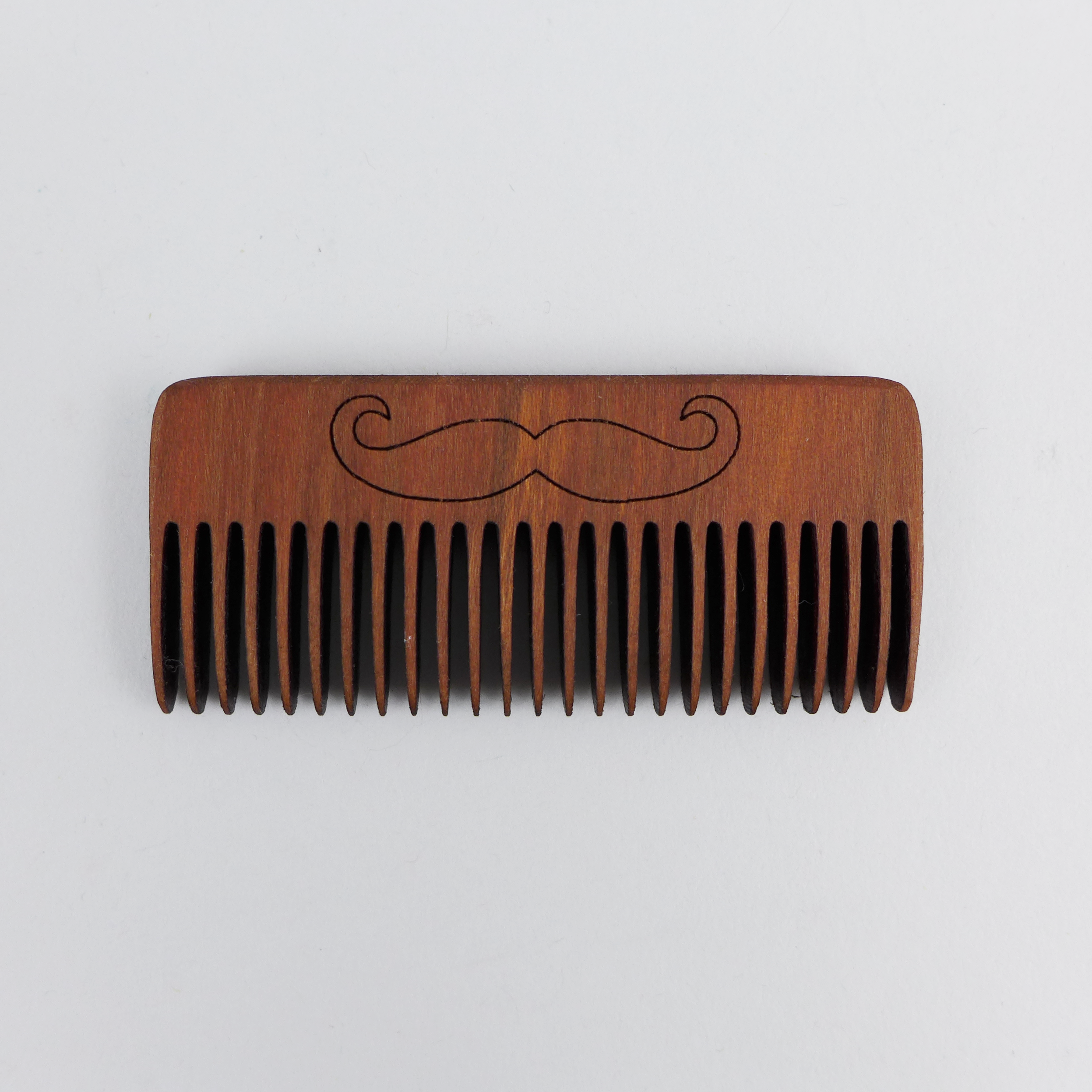 Beard comb is made out of solid cherry wood by Hannah’s Ideas in Wood at the Center for Art in Wood