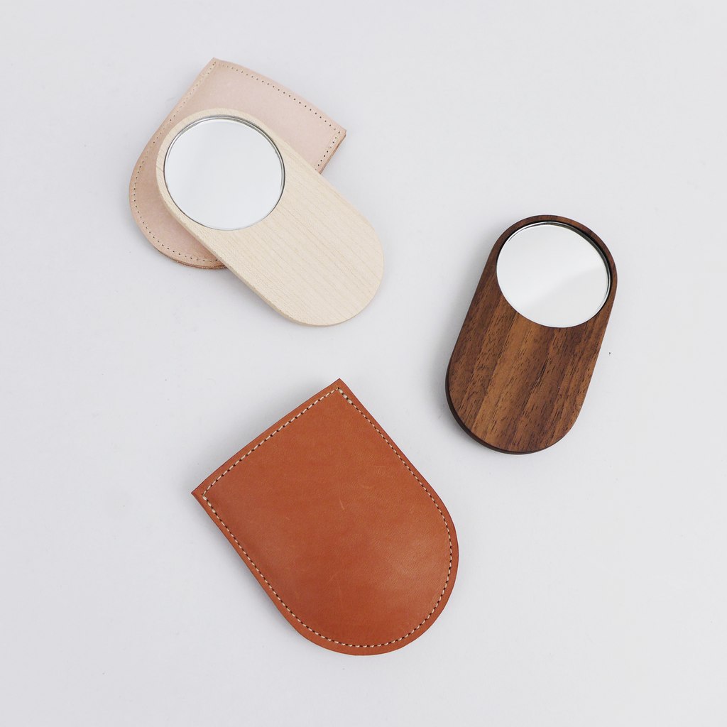 Shaped from solid walnut, these small mirrors are designed to sit comfortably in your hand by Heide Martin at the Center for Art in Wood