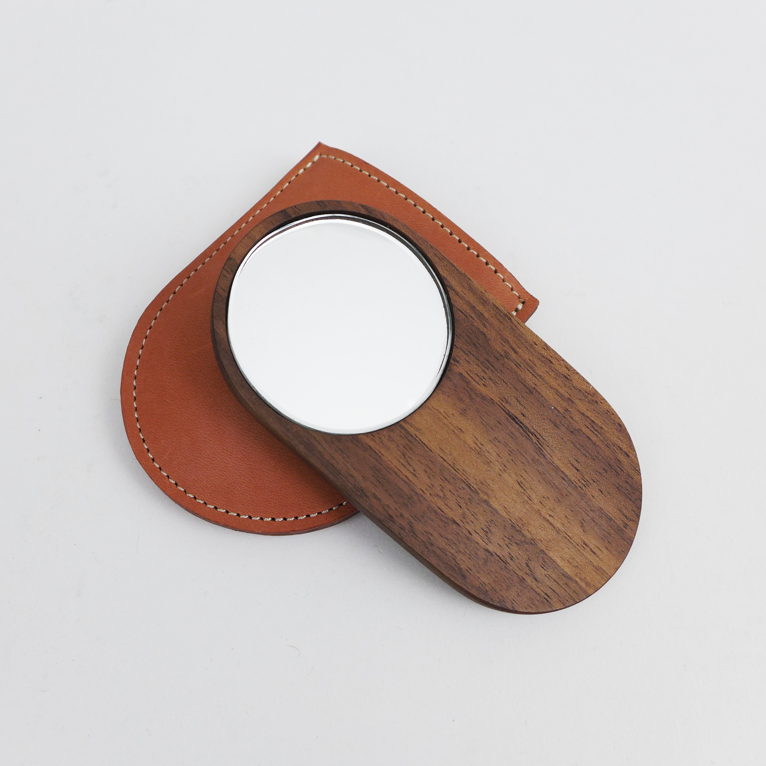 Shaped from solid walnut, these small mirrors are designed to sit comfortably in your hand by Heide Martin at the Center for Art in Wood